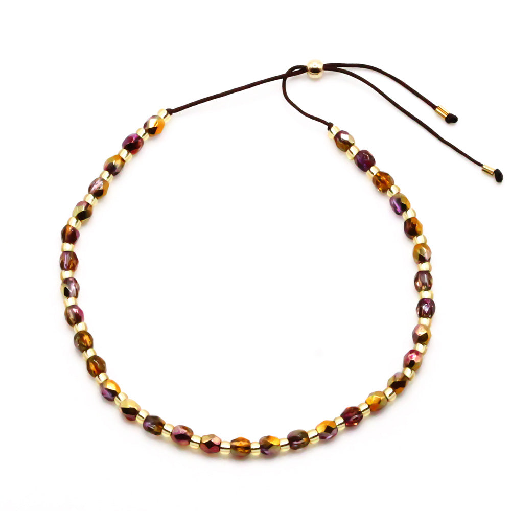 Perlenarmband mit Kristallen golden lila