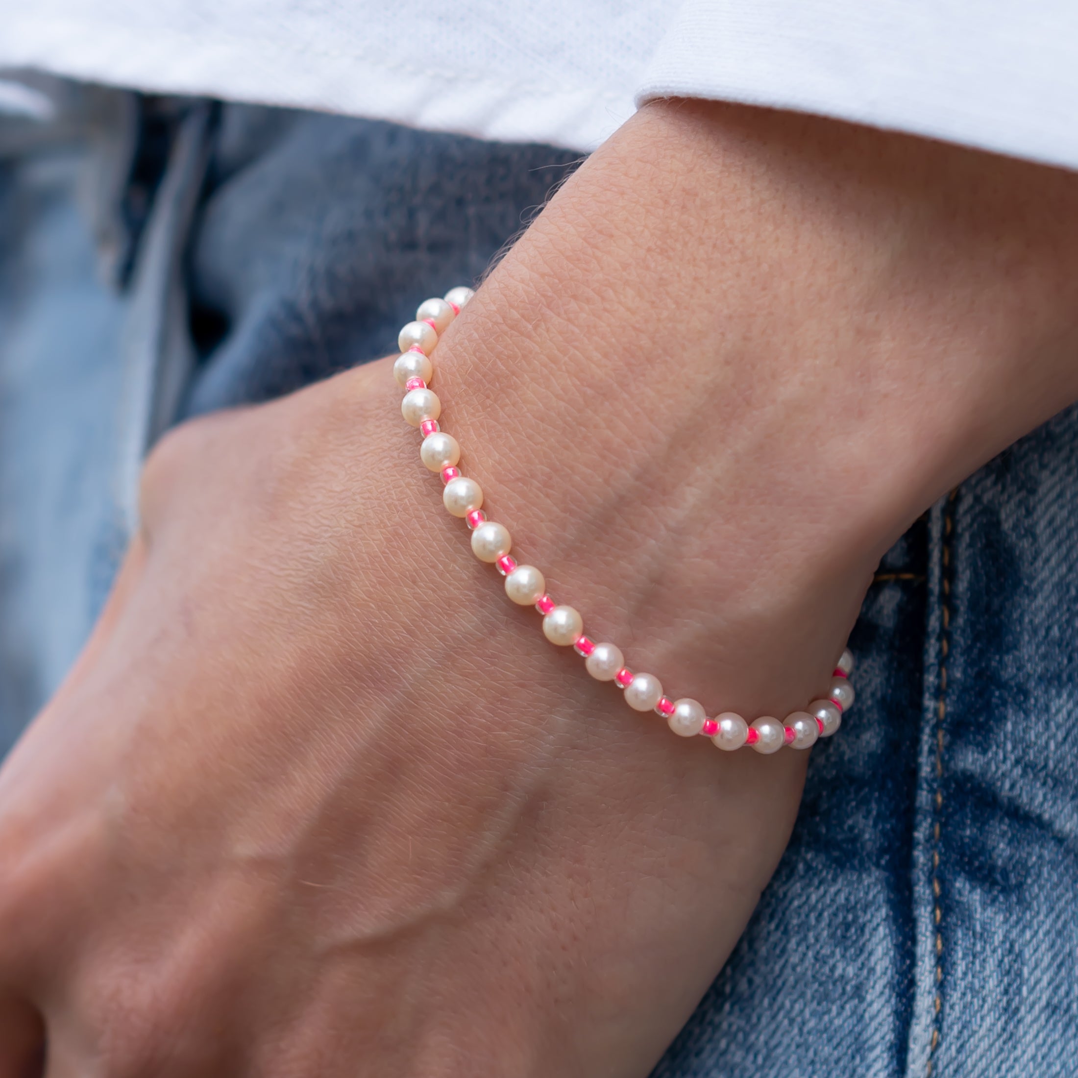 Handgemachtes Perlenarmband für Damen mit zarten pinken Perlen und kleinen weißen Perlen an Handgelenk, lässig kombiniert zu . - Perlenarmband Rebell in luminous pink, orange, blau, rosa oder goldgelb - Apricot/Orange, Blau, Gelb, Pink