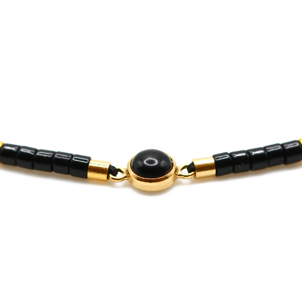 Perlenarmband mit Anhänger in schwarz Gold