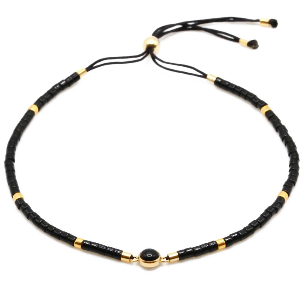 Perlenarmband in schwarz gold