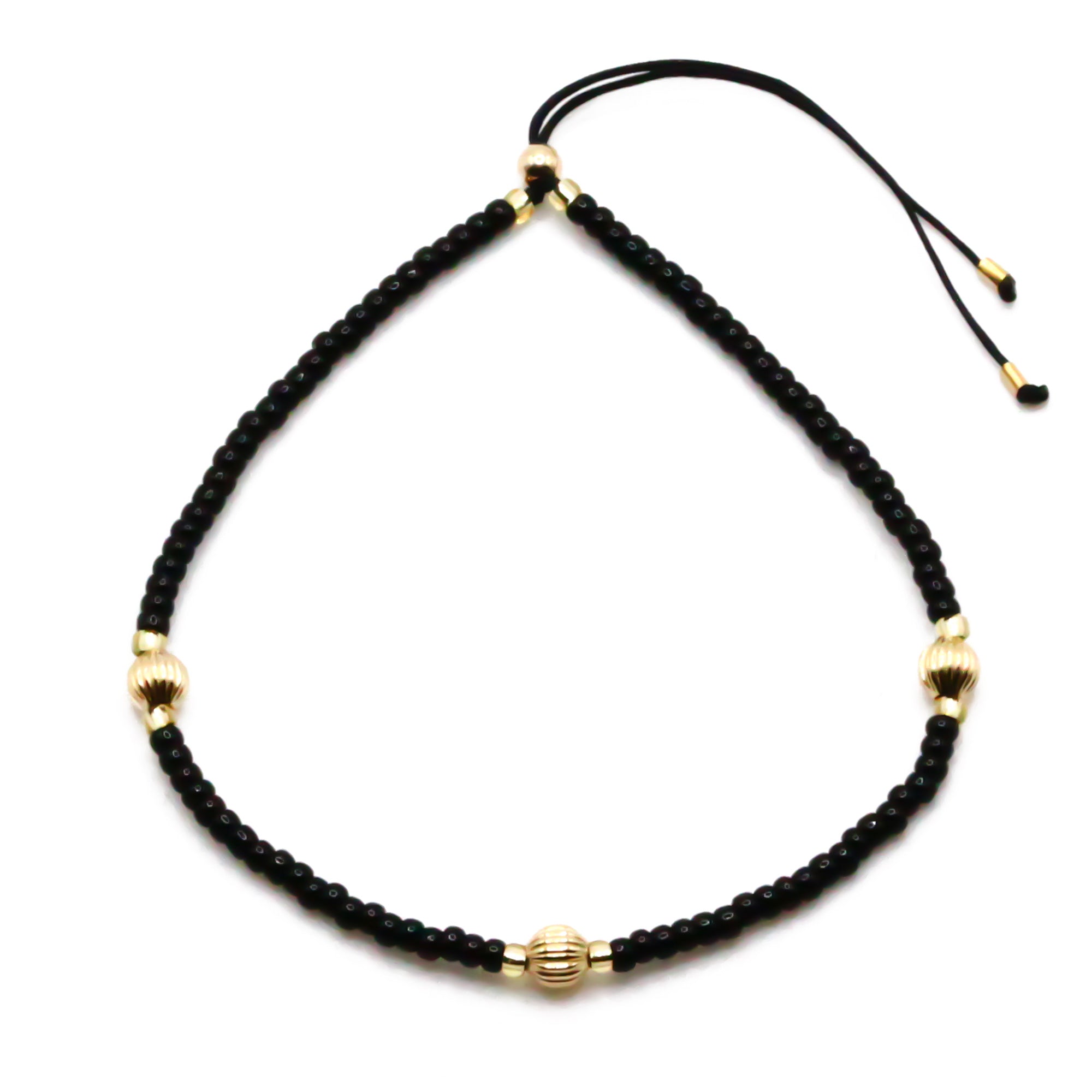 schwarzes armband mit gold perlen