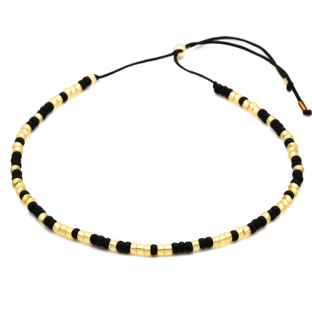Perlenarmband schwarz gold
